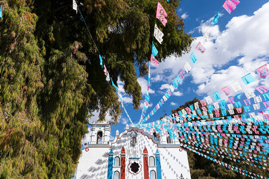 Church facade with paper decorations and the sky 