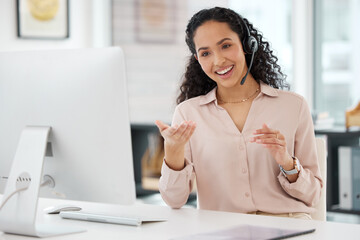 Communicating with customers on several channels. Shot of a young call centre agent working on a computer in an office.
