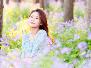 Portrait of elegant Chinese girl in dress enjoy carefree time in forest park in sunny day. Outdoor fashion portrait of glamour young Chinese cheerful stylish woman.