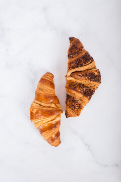 Two croissants on marbled table