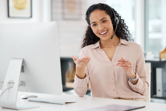 Communicating with customers on several channels. Shot of a young call centre agent working on a computer in an office.
