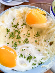 Eggs in a big cup with coriander for breakfast