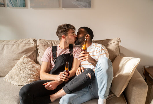 Gay Couple In Love Having Drinks At Home