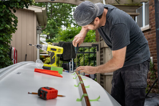 Caulking Mahogany Trim on Hull of Restored Dinghy Sailboat