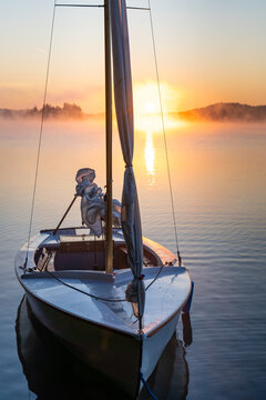 Small Sailboat on Freshwater Lake At Sunrise