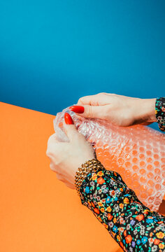 Hands popping bubble wrap