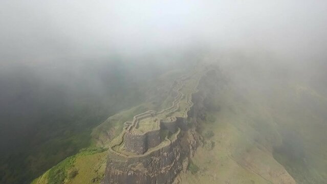 Old overgrown Zunjar Machi fortifications aerial from, cloud into sun
