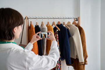 Young woman shooting garments at home