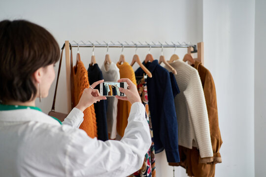Young woman shooting garments at home
