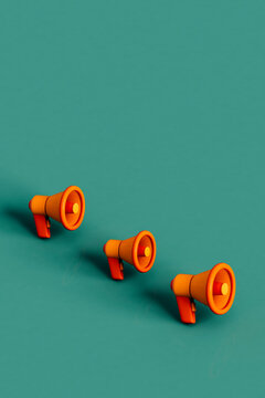 a row of Orange megaphones on green. 3d render