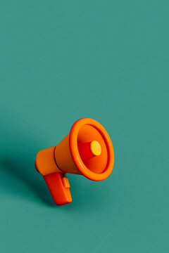 close up of Orange megaphones on green. 3d render