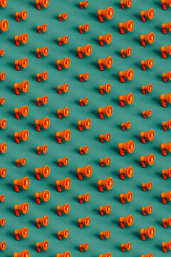 pattern of Orange megaphones in different position on green. 3d render