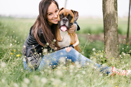 Woman with a boxer dog