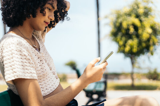 Young trans woman checking her phone