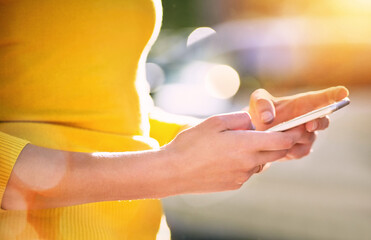 Get your message across with smart technology. Cropped shot of an unrecognizable young woman using...