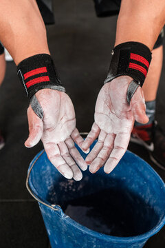 Anonymous athlete spreading magnesium on hands