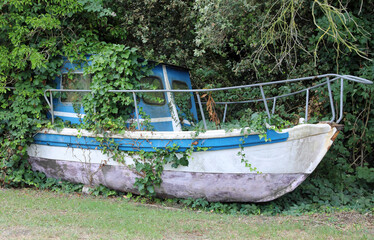 wreck of an abandoned boat in the forest after transporting