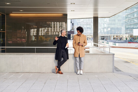 Businessmen talking outside during their lunch break