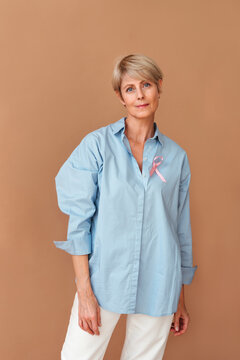 Middle aged woman with pink ribbon.
