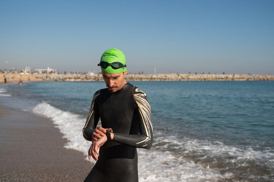 Man In Wetsuit Using Wristwatch 