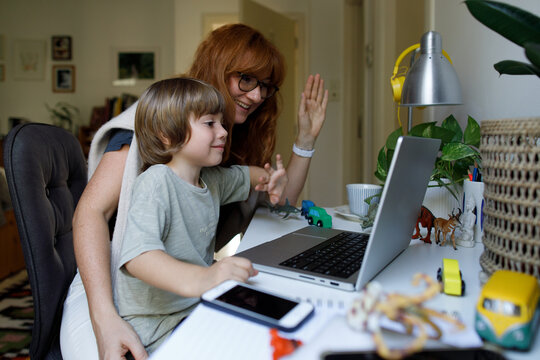 Mom and son talking online at home