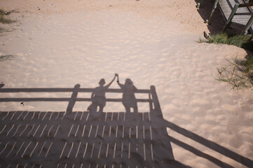 Silhouette of couple holding hands 