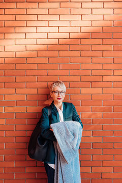 Woman in front of Brick Wall