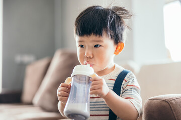 Asian little baby boy drinking milk