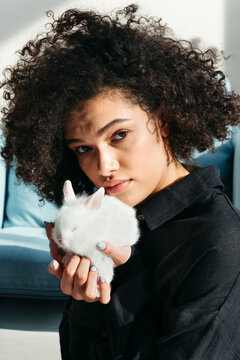 Portrait of mixed race woman with pet rabbit.