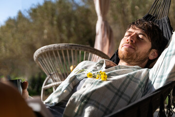 Portrait of happy man relaxing on hammock