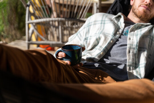 Portrait of happy man relaxing on hammock