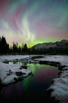 Northern Lights with Reflectio in Alaska's Mountains Over Thawed River