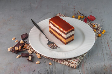 layered Snickers cake on gray background
