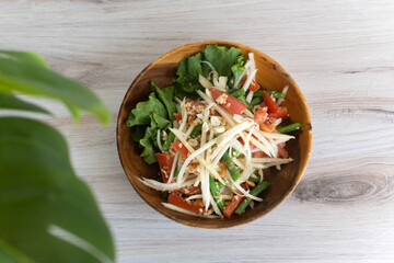 Papaya salad on wooden table
