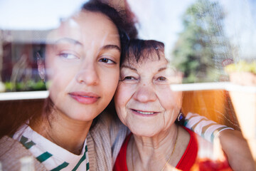 Smiling grandmother and granddaughter together