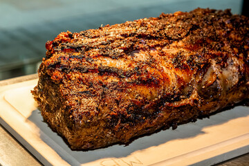 Baked roast beef from rib eye of marbled beef lies on the board