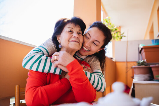 Moment of tenderness between granddaughter and grandmother