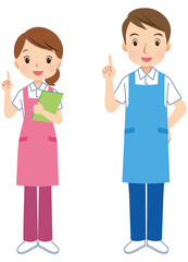 エプロンをつけた男女　説明する介護士　スタッフ