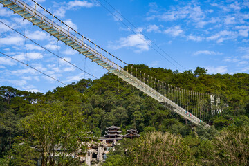 High-altitude pedestrian glass suspension bridge in the park