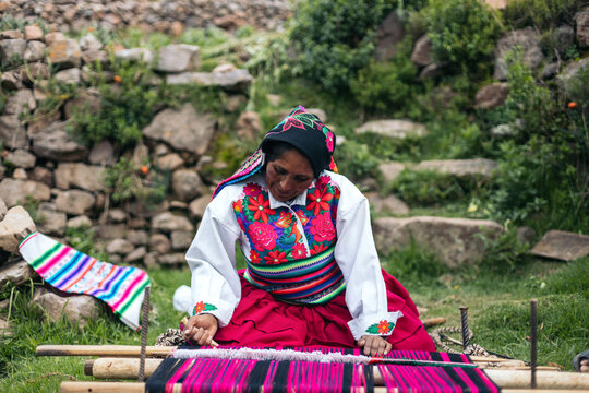 Peruvian woman weaving using a loom