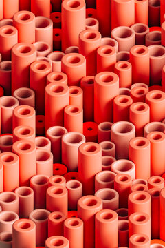 Three dimensional pattern of rows of red colored cylinders