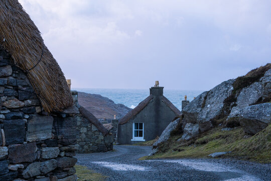 historic thatch stone houses on a wild coast
