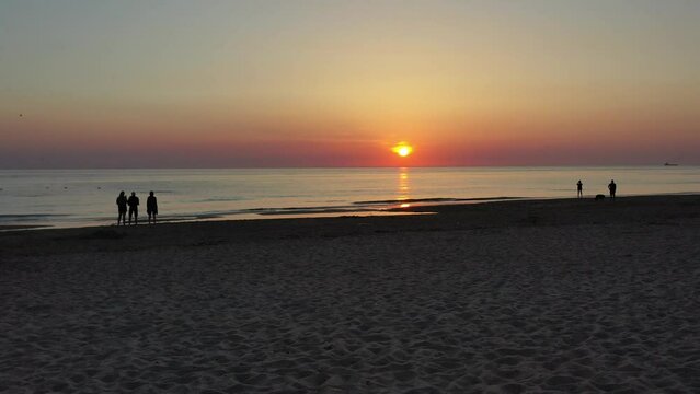 Drohnenaufnahme, Drohnenflug &uuml;ber den Strand mit Menschen, die Nordseek&uuml;ste und die Nordsee dem Sonnenuntergang entgegen, Julianadorp, Nordholland, Den Helder, Niederlande