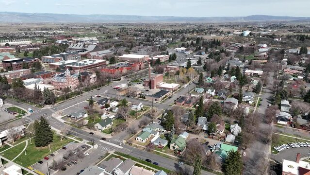 Cinematic 4K aerial drone trucking shot of the Central Washington University campus and neighboring residential area in the city of Ellensburg, Kittitas County in Western Washington