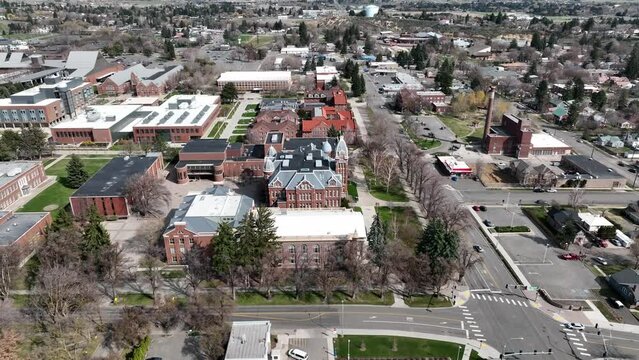 Cinematic 4K aerial drone trucking shot of Central Washington University campus main buildings in the city of Ellensburg, Kittitas County in Western Washington