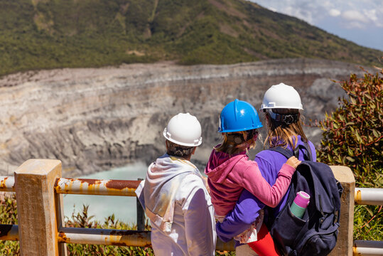 Family in safety helmets at Crater Observation area of Poas Volcano 