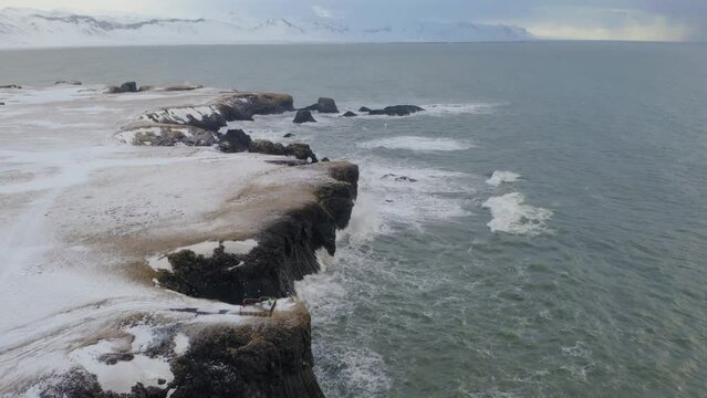 Waves Crashing On Arnarstapi Cliff And Coastline In Iceland. - aerial