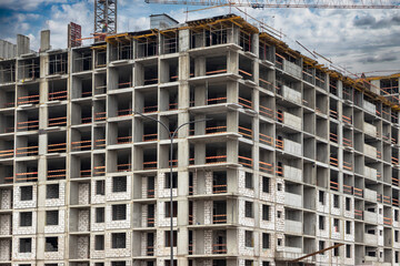 Monolithic frame construction of the building. Solid walls of concrete. The framework for the walls. Formwork for walls made of concrete. Construction site close up.