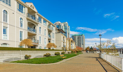Fototapeta na wymiar Neighborhood modern houses on sunny day in BC, Canada. Canadian modern residential architecture.