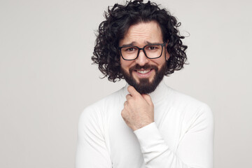 Happy bearded man with curly hair in studio